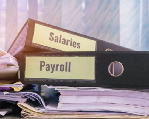 Payroll and salaries folders stack with label on black binder on paperwork documents summary report, HR-human resources business and bookkeeping accountancy concept in busy offices